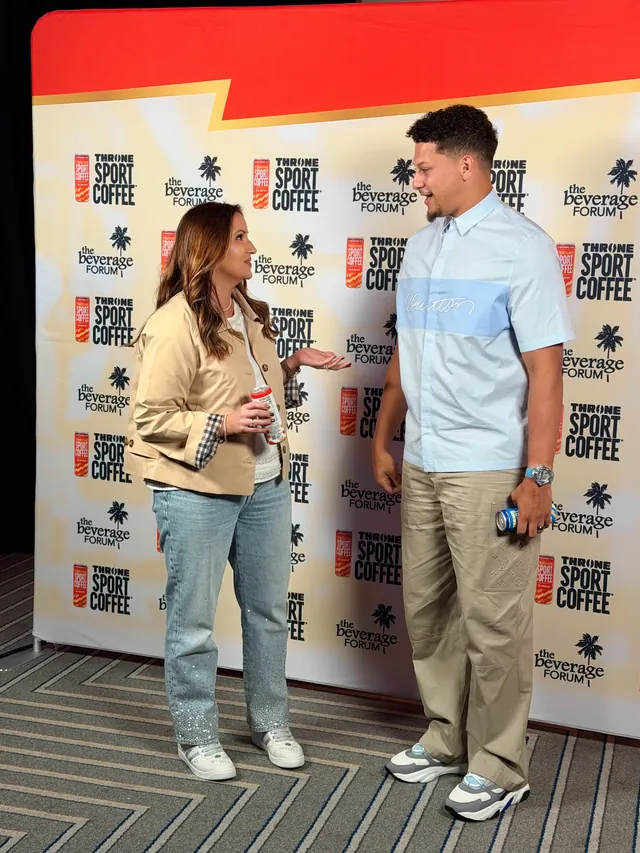 Joey Pedone, investing partner, talking with a guest at the THRONE Sport Coffee backdrop at The Beverage Forum