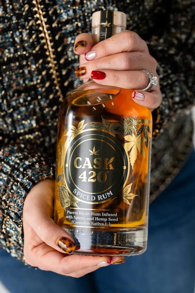 A hand holding a whiskey bottle from a brand in the CAYD CAP portfolio